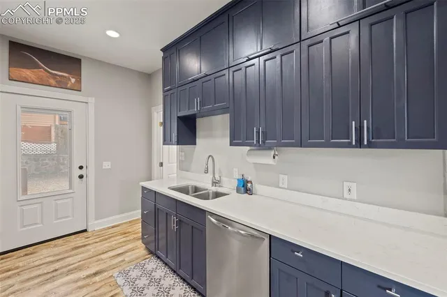 a kitchen with a sink cabinets and wooden floor