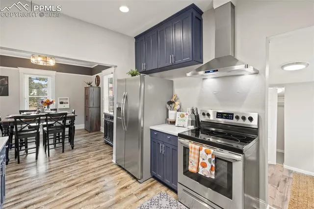 a kitchen with granite countertop a stove a sink and a refrigerator