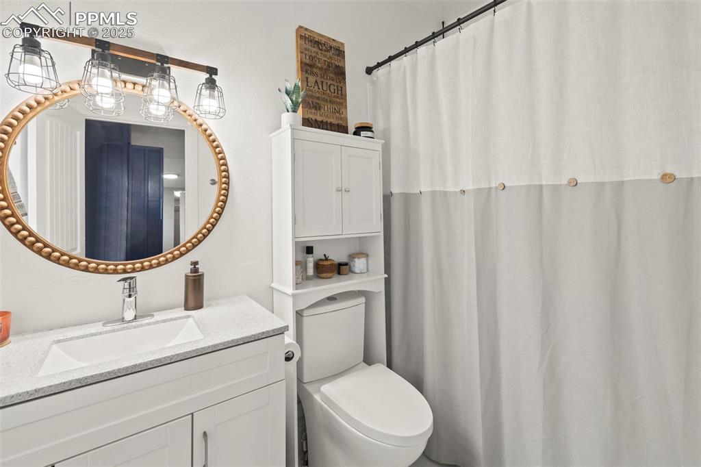 1904 Sheldon Avenue Colorado Springs, CO 80904 - Photo 16 of 40 a bathroom with a toilet a sink and a mirror
