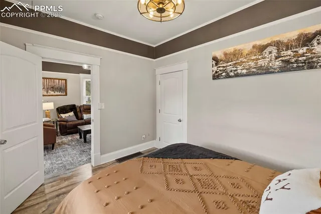 a bedroom with a bed and a mirror on the wall