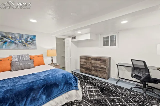 a bedroom with a bed and a fireplace