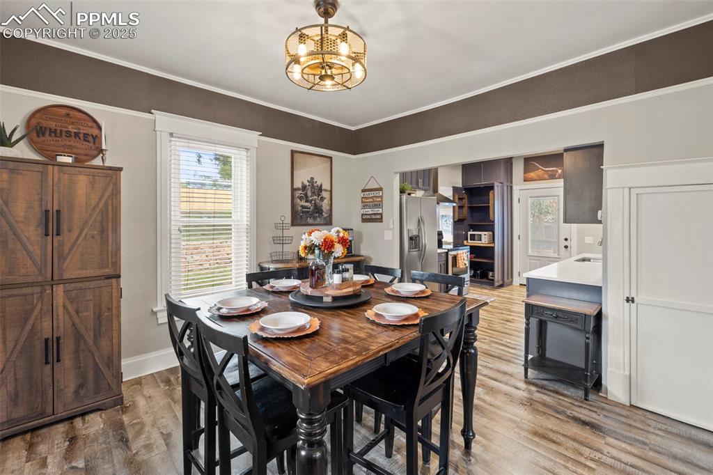 1904 Sheldon Avenue Colorado Springs, CO 80904 - Photo 7 of 40 a view of a dining room with furniture window and wooden floor