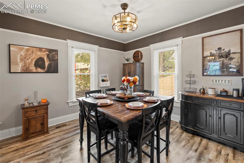 1904 Sheldon Avenue Colorado Springs, CO 80904 - Photo 10 of 40 a view of a dining room with furniture window and wooden floor
