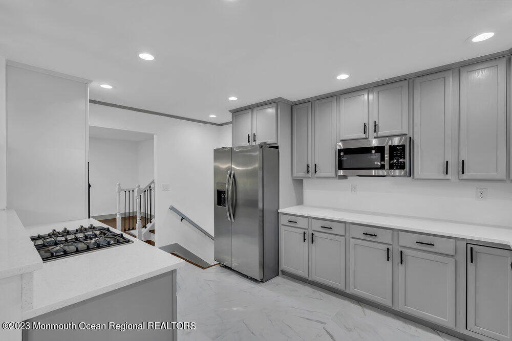 111 Sun Valley Road Toms River, NJ 08755 - Photo 13 of 51 a kitchen with stainless steel appliances a sink a stove a refrigerator and cabinets