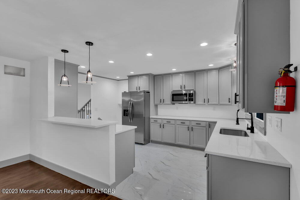 111 Sun Valley Road Toms River, NJ 08755 - Photo 14 of 51 a kitchen with sink cabinets and refrigerator