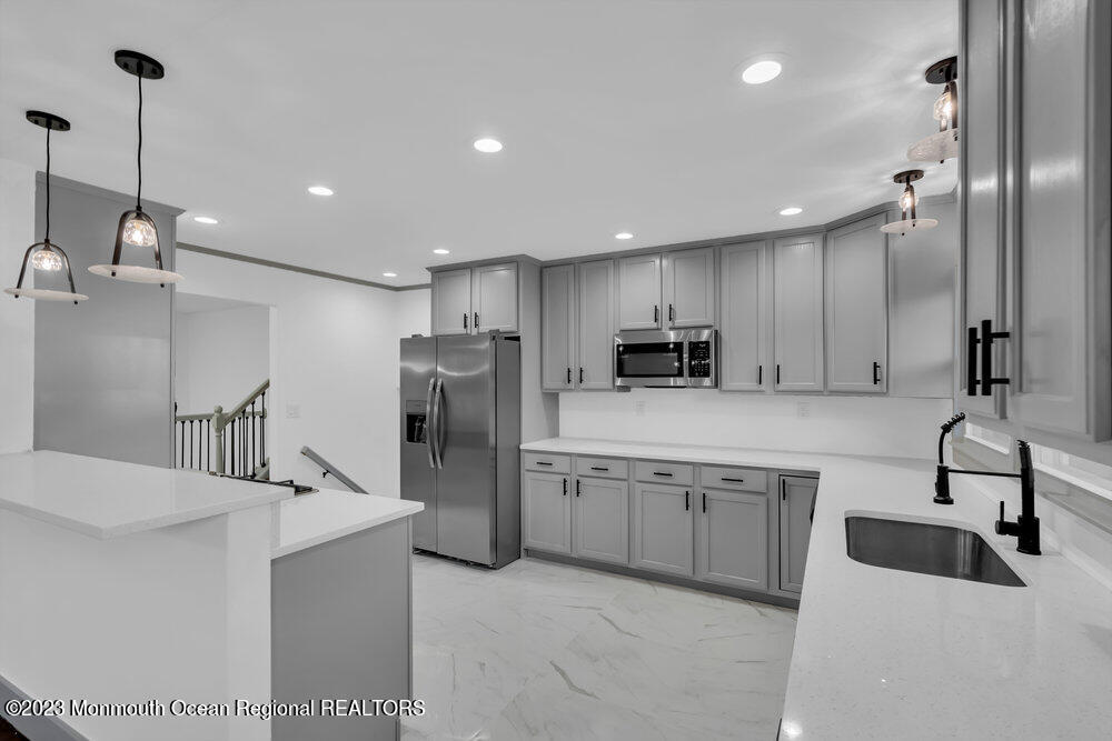111 Sun Valley Road Toms River, NJ 08755 - Photo 15 of 51 a kitchen with refrigerator and cabinets