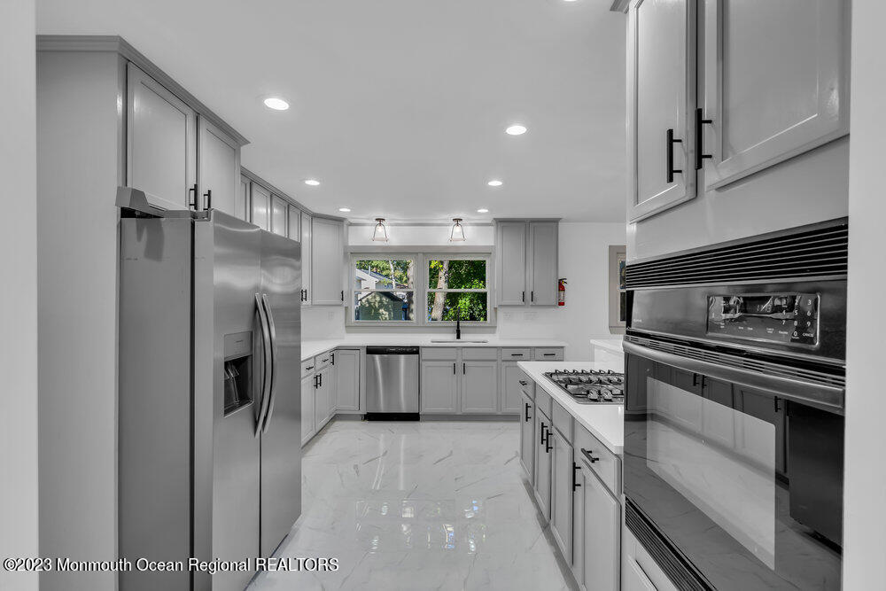 111 Sun Valley Road Toms River, NJ 08755 - Photo 18 of 51 a kitchen with a sink stove and refrigerator