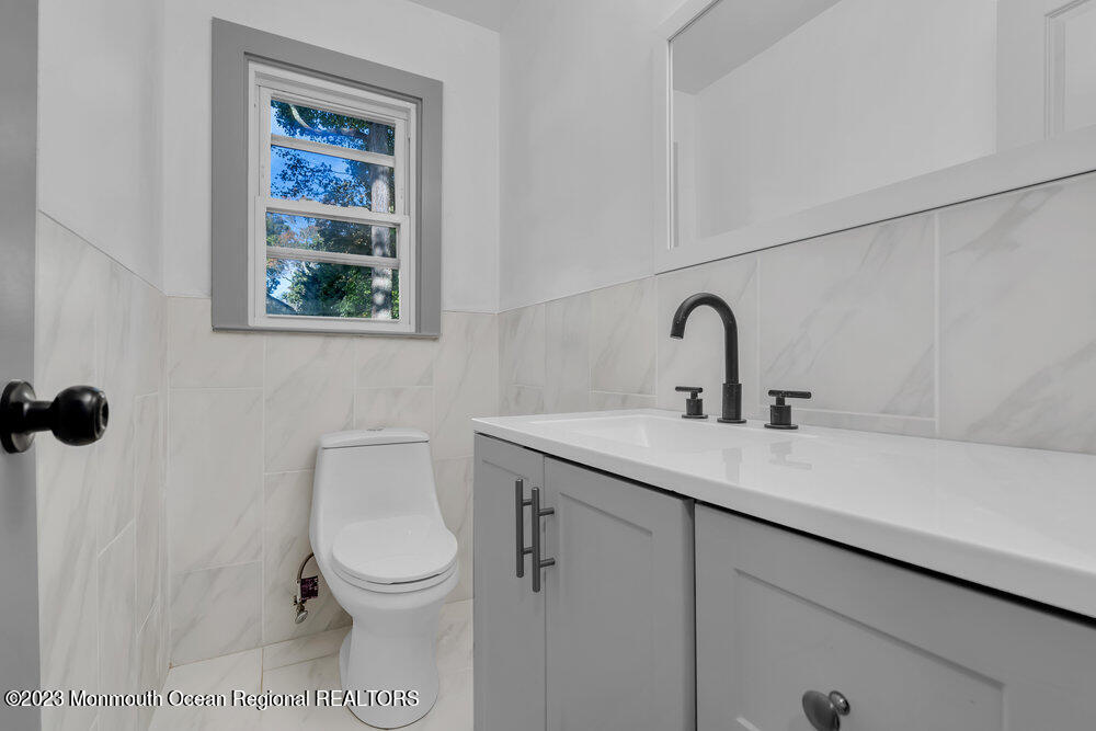 111 Sun Valley Road Toms River, NJ 08755 - Photo 22 of 51 a bathroom with a toilet sink and mirror