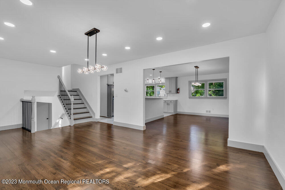 111 Sun Valley Road Toms River, NJ 08755 - Photo 23 of 51 a view of an empty room with wooden floor kitchen view and a window