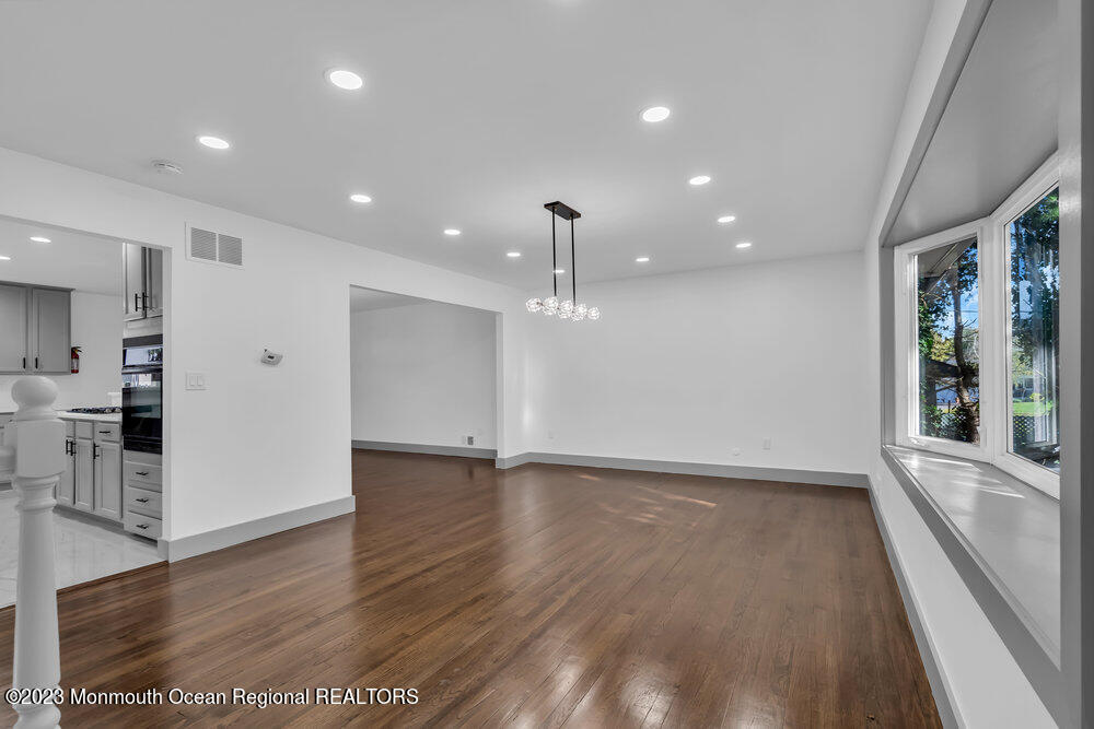 111 Sun Valley Road Toms River, NJ 08755 - Photo 25 of 51 an empty room with wooden floor and windows
