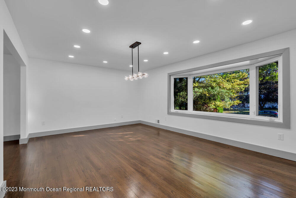 111 Sun Valley Road Toms River, NJ 08755 - Photo 26 of 51 a view of an empty room with wooden floor and a window