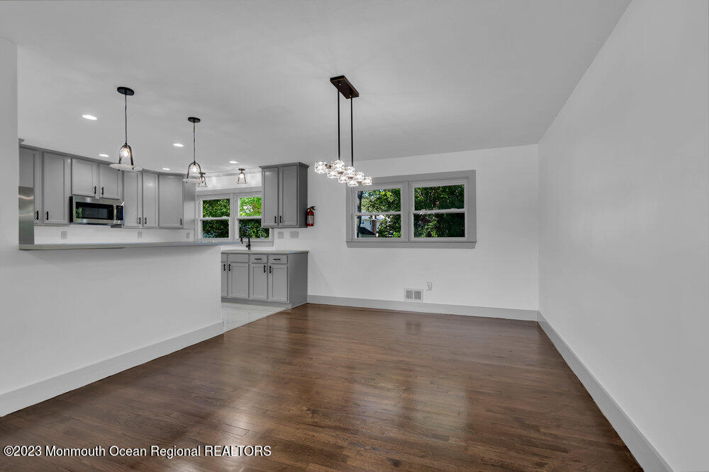 111 Sun Valley Road Toms River, NJ 08755 - Photo 28 of 51 a view of a kitchen with a microwave and wooden floor