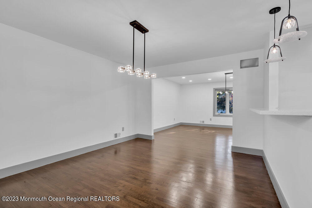 111 Sun Valley Road Toms River, NJ 08755 - Photo 29 of 51 a view of a room with wooden floor and a ceiling fan