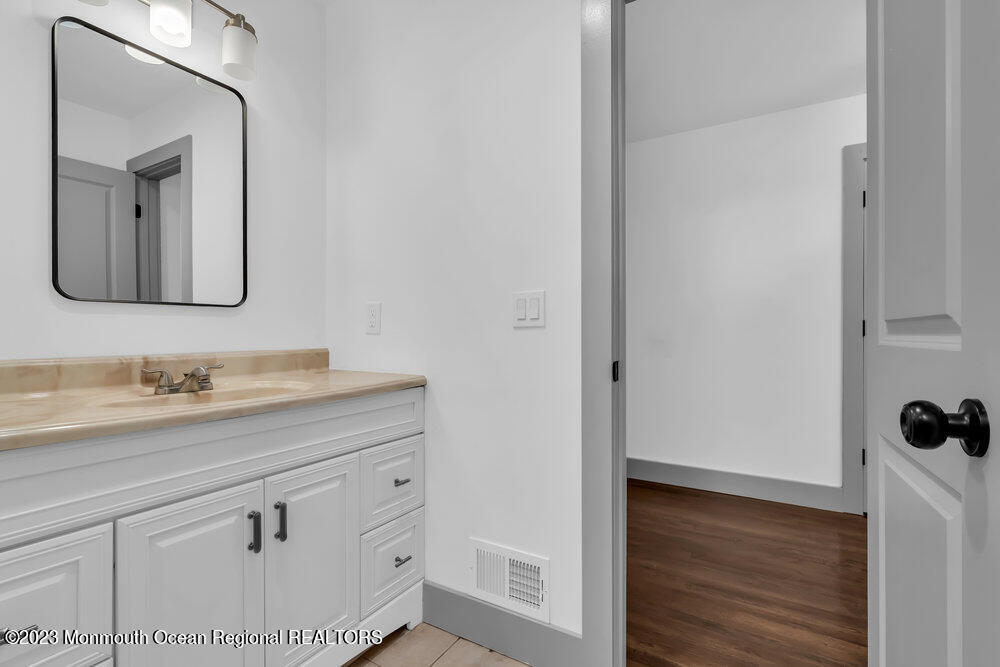 111 Sun Valley Road Toms River, NJ 08755 - Photo 35 of 51 a bathroom with a sink and a mirror