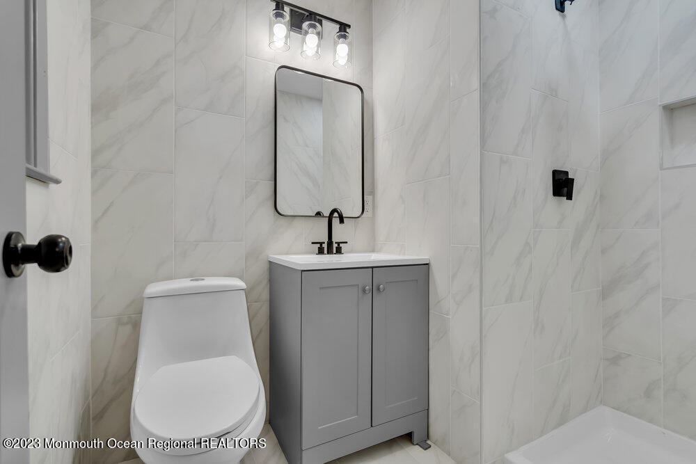 111 Sun Valley Road Toms River, NJ 08755 - Photo 37 of 51 a bathroom with a toilet a sink and mirror
