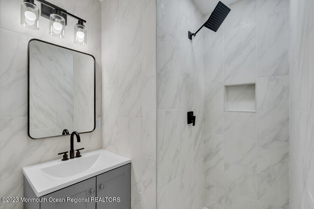 111 Sun Valley Road Toms River, NJ 08755 - Photo 38 of 51 a bathroom with a sink a mirror and vanity