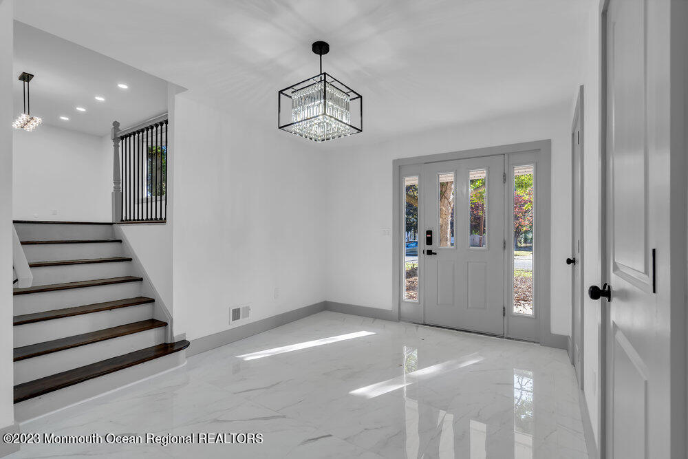 111 Sun Valley Road Toms River, NJ 08755 - Photo 6 of 51 a view of a livingroom with wooden floor and stairs