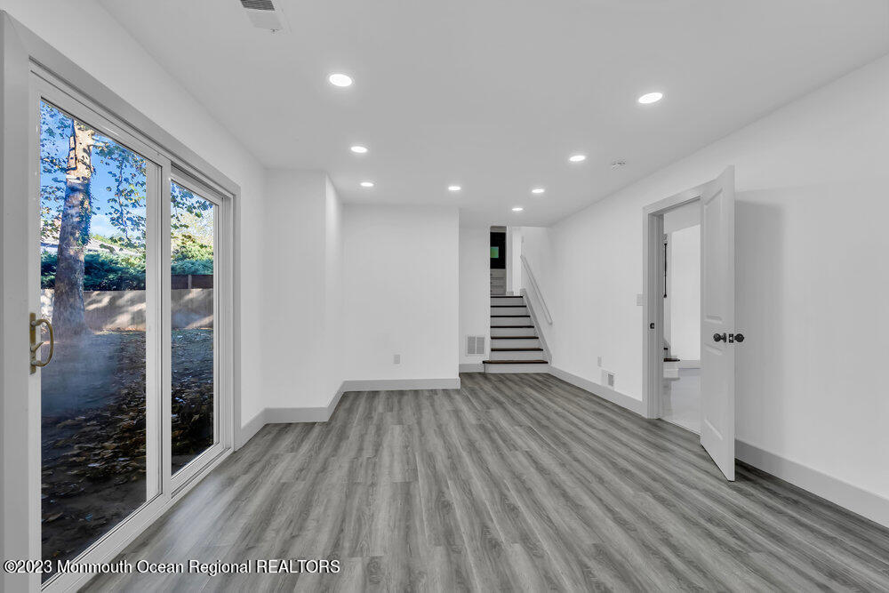111 Sun Valley Road Toms River, NJ 08755 - Photo 10 of 51 a view of wooden floor and windows in a room