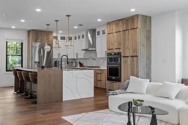 a kitchen with stainless steel appliances granite countertop a refrigerator and a stove top oven