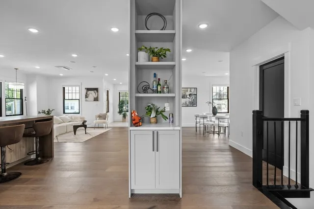 a living room with furniture and a wooden floor