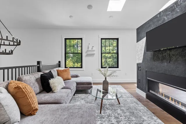 a living room with furniture fireplace and window