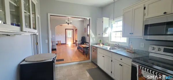 a kitchen with stainless steel appliances granite countertop a sink stove and cabinets