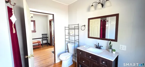 a en suite bathroom with a sink a vanity and a mirror