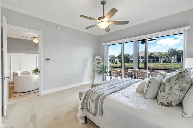 a bedroom with bed and a large window