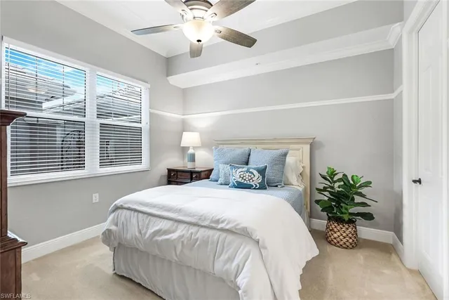 a bedroom with a bed and a potted plant