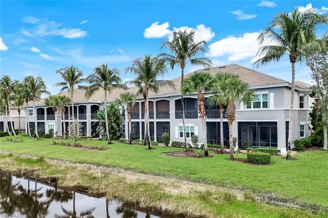 a front view of a house with a garden and trees