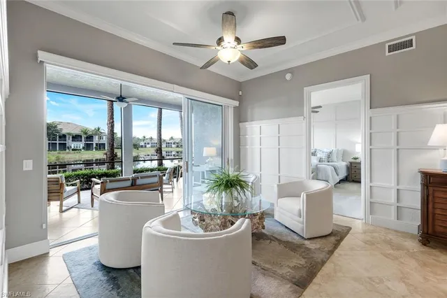 a living room with furniture a fireplace and a potted plant