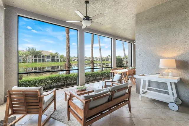 a living room with furniture and a floor to ceiling window