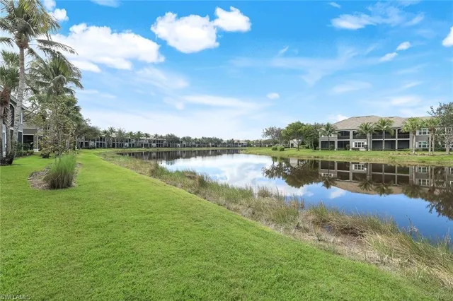 a view of a lake with houses in the back