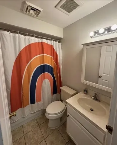 a bathroom with a toilet a sink and a mirror