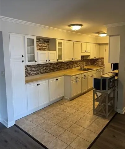 a kitchen with stainless steel appliances granite countertop a sink and cabinets