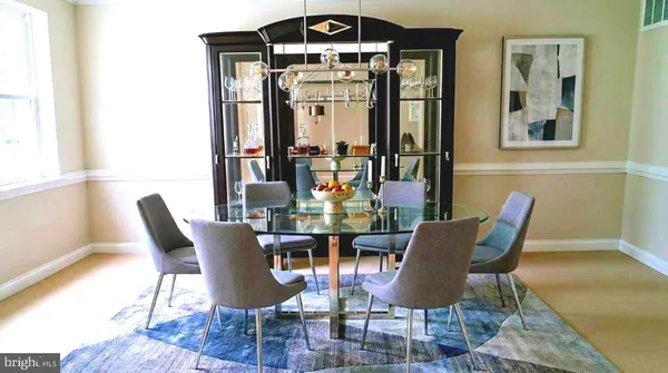 a living room with furniture and a dining table