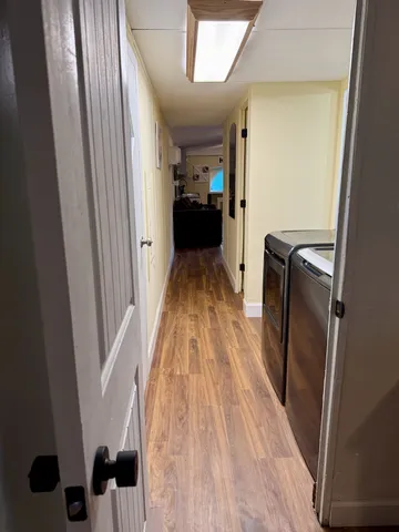 a view of closet with wooden floor