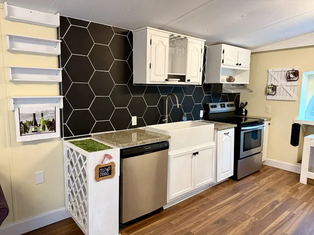 a kitchen with a sink cabinets and wooden floor