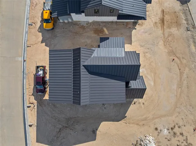 a view of swimming pool that has lawn chairs and a dining table under an umbrella
