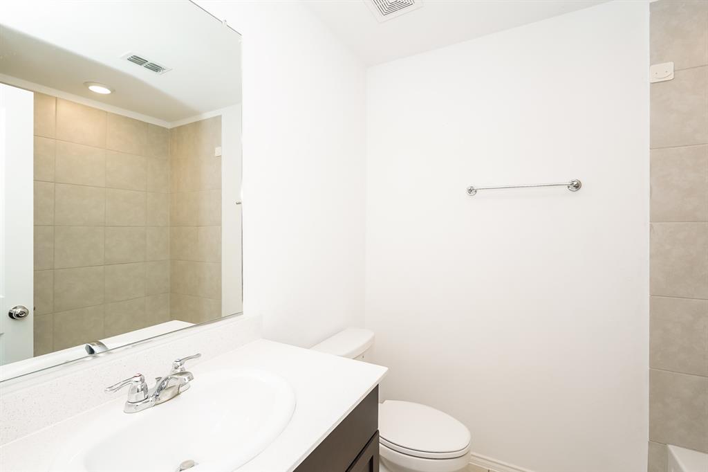 14841 Firerock Road Haslet, TX 76052 - Photo 17 of 18 a bathroom with a sink a toilet and mirror