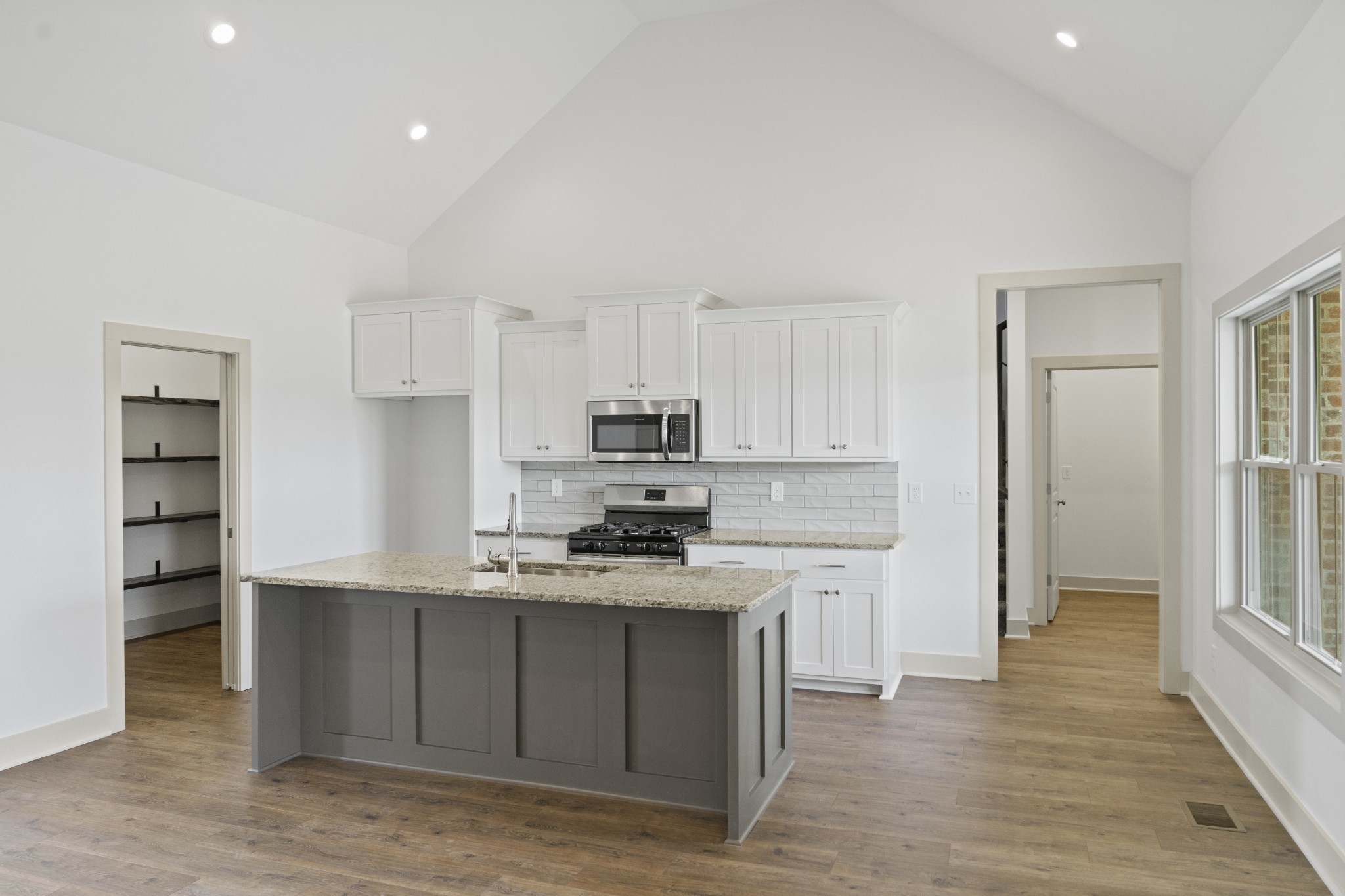 3390 Calista Road White House, TN 37188 - Photo 9 of 25 a kitchen with stainless steel appliances granite countertop a stove a sink and a refrigerator