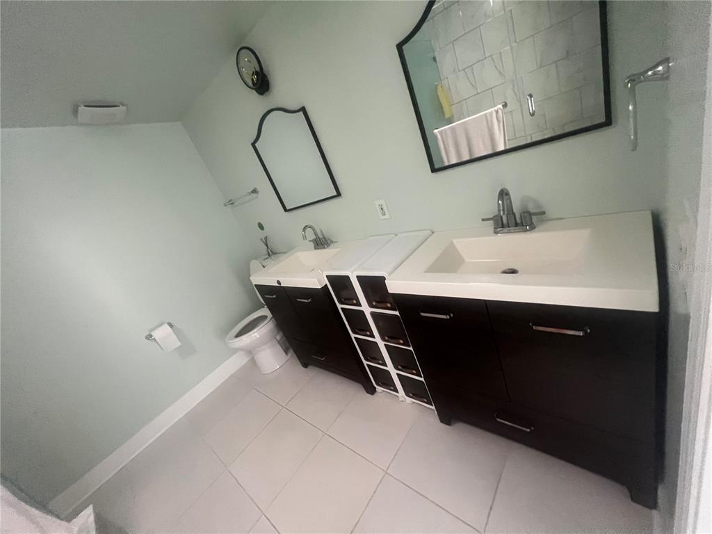 5855 Jack Brack Road St. Cloud, FL 34771 - Photo 13 of 86 a bathroom with a sink and mirror