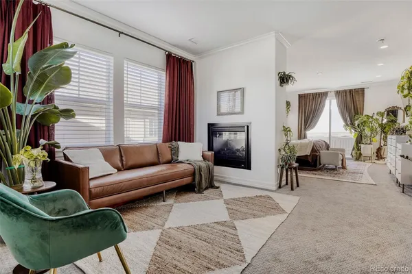 a bedroom with a bed a couch and a potted plant