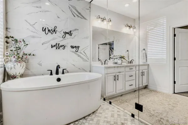 a bathroom with a double vanity sink mirror and shower