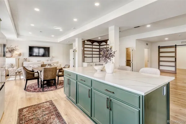 a bedroom with a bed and walk in closet with wooden floor