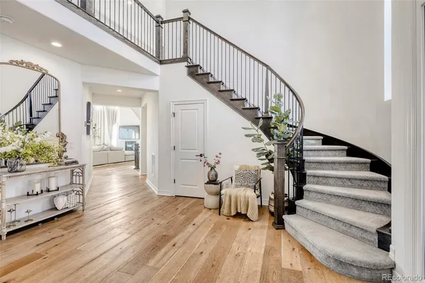 a view of entryway and hall with wooden floor