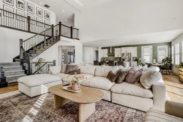 a living room with furniture a rug and a chandelier