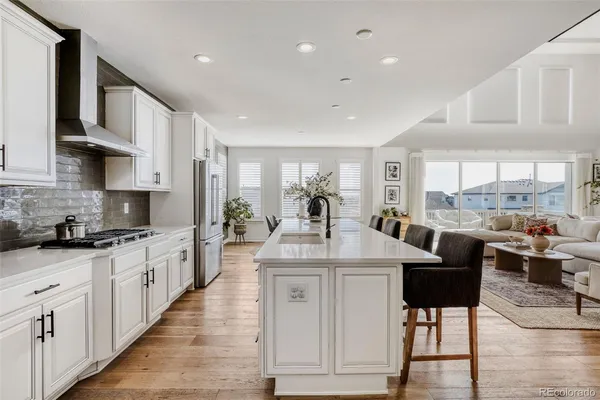 a large kitchen with stainless steel appliances kitchen island granite countertop a large cabinets a sink and a counter