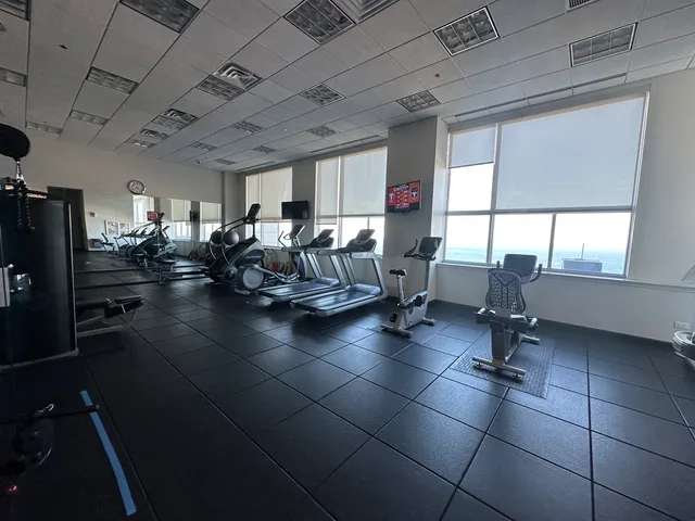 a living room with lots of furniture and a floor to ceiling window