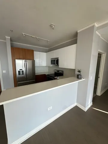 a view of kitchen with stainless steel appliances a refrigerator and a stove